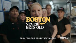 A group of Kitchen workers, led by chef Tiffany Faizon, appear with the text, “Boston never gets old.”